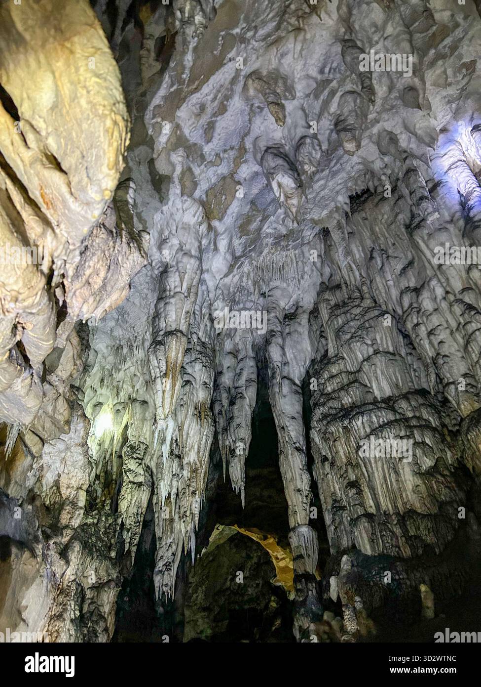Impressive stalactites and limestone formations inside the Ice Cave in Uvac Canyon, Serbia, illuminated by soft light revealing the cave’s ancient geo - Smartphone Captured Stock Image