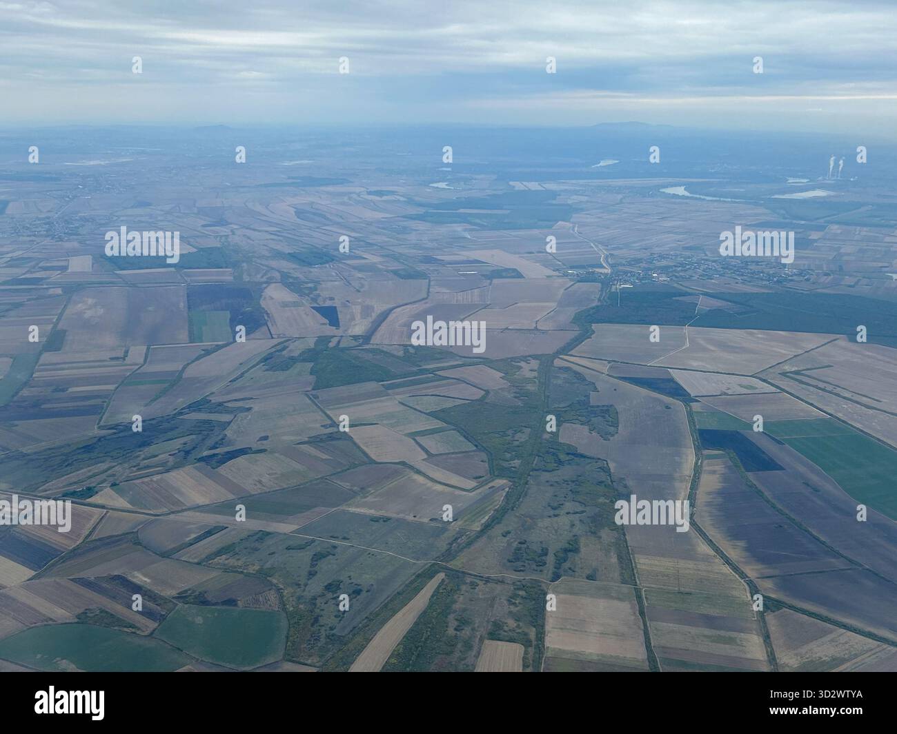 High-angle aerial image of a rural agricultural region, showing diverse field sizes and soil textures. - Smartphone Captured Stock Image