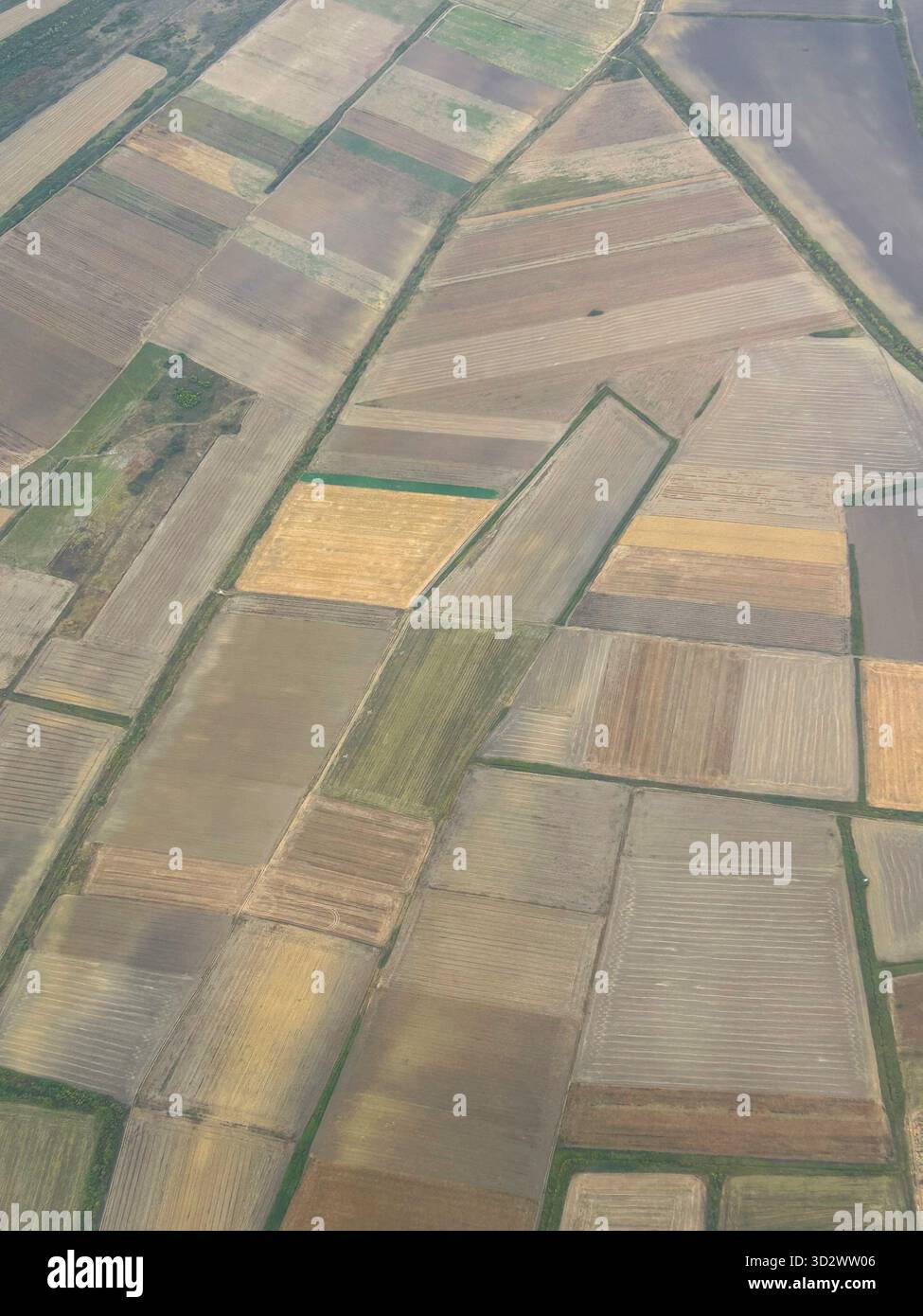 Aerial landscape photo capturing large rural fields, ready for planting, with natural earthy tones. - Smartphone Captured Stock Image