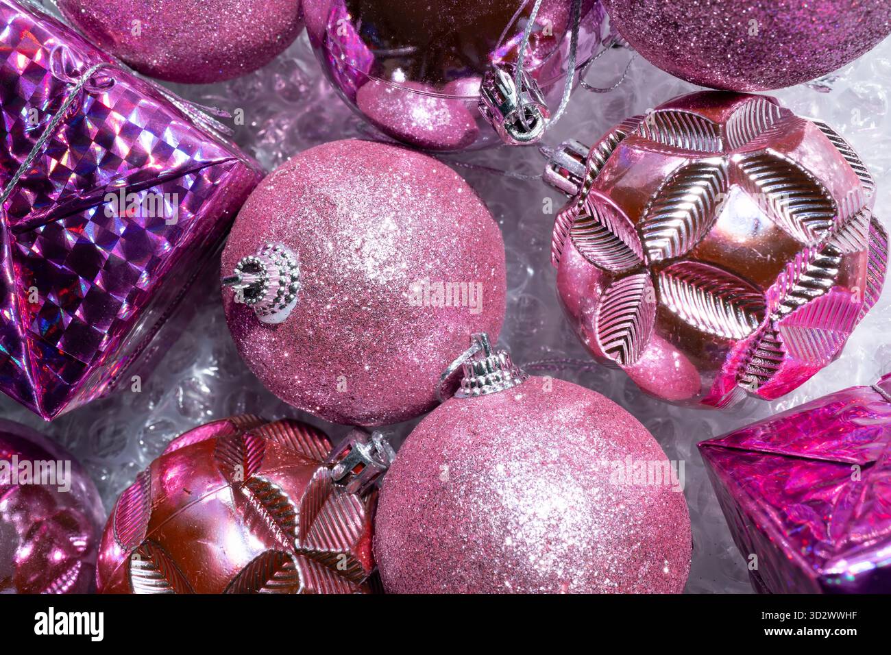 Pink Christmas tree decorations on bubble wrap Stock Photo