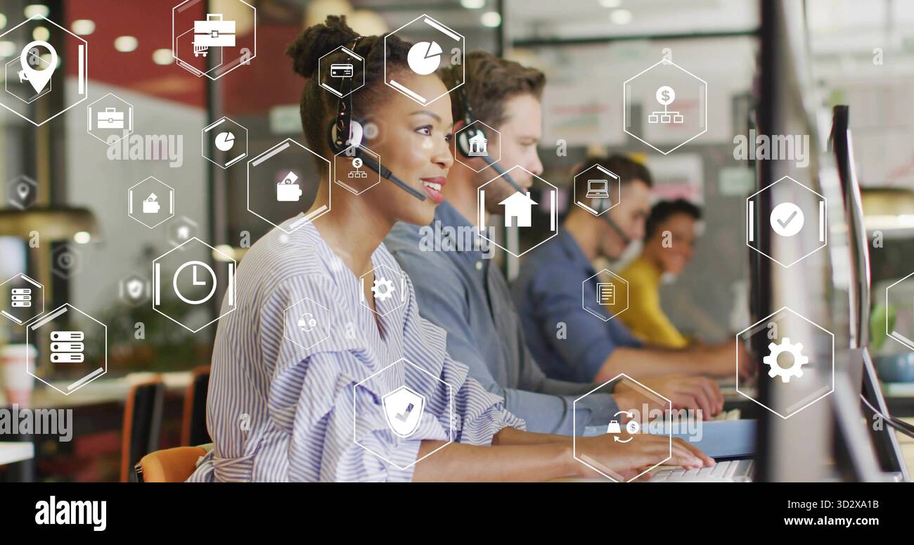Typing call center rep with headset in office, with monitors, keyboard ...