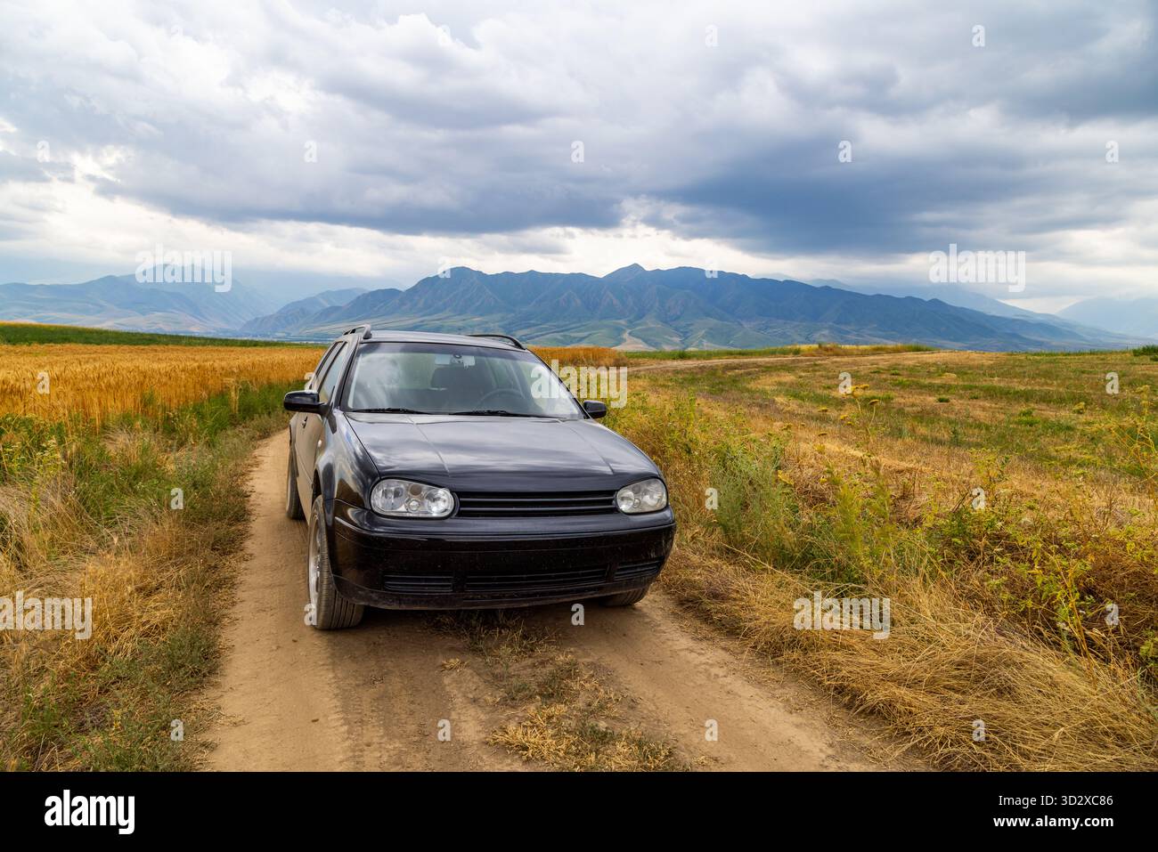 Black car driving through field hi-res stock photography and images - Alamy