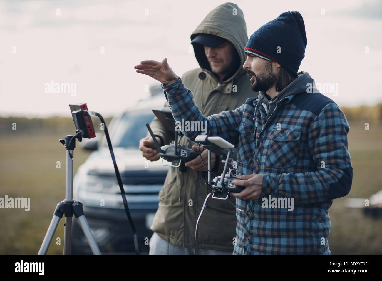 Man pilot controlling quadcopter drone with remote controller pad Stock Photo