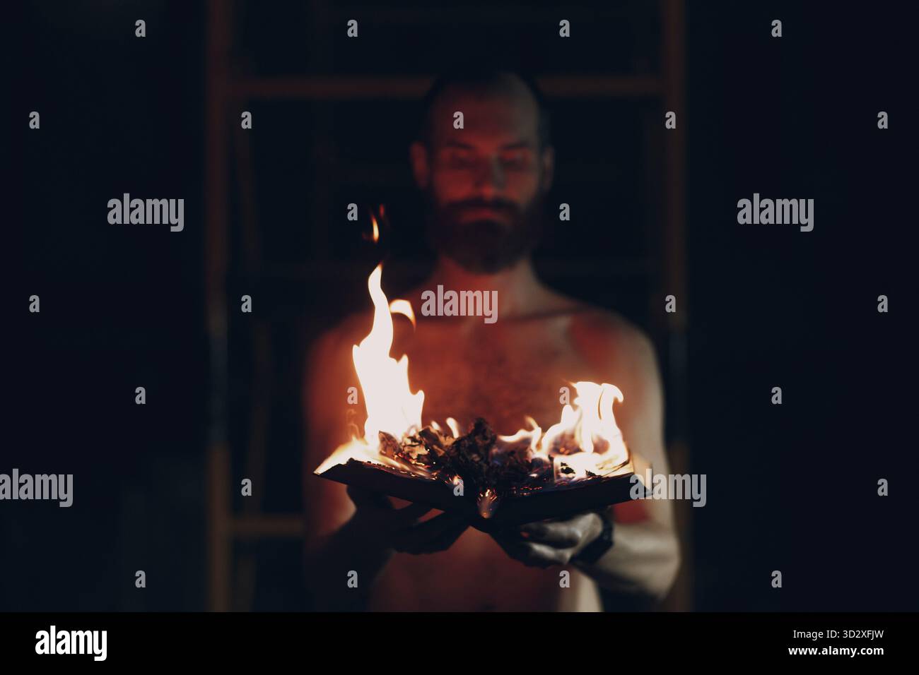 Man hold burning book in his hands Stock Photo