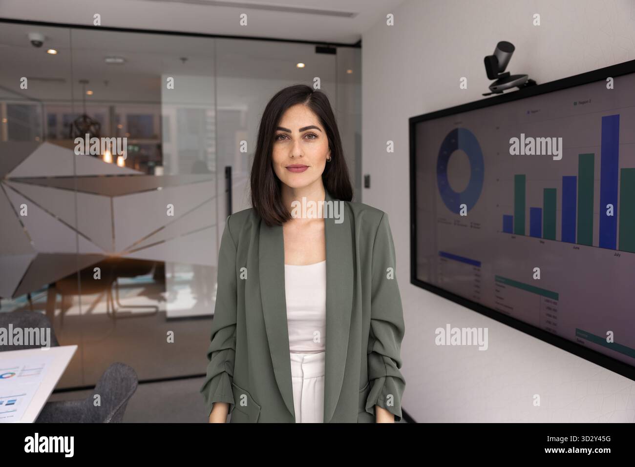 Confident beautiful young Latin business woman posing in office Stock ...