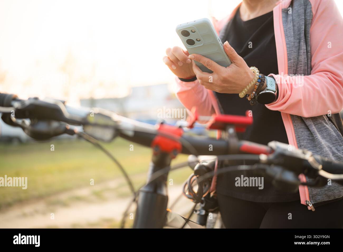 Woman Checking Bike Route On A Smartphone With Gps Map Stock Photo