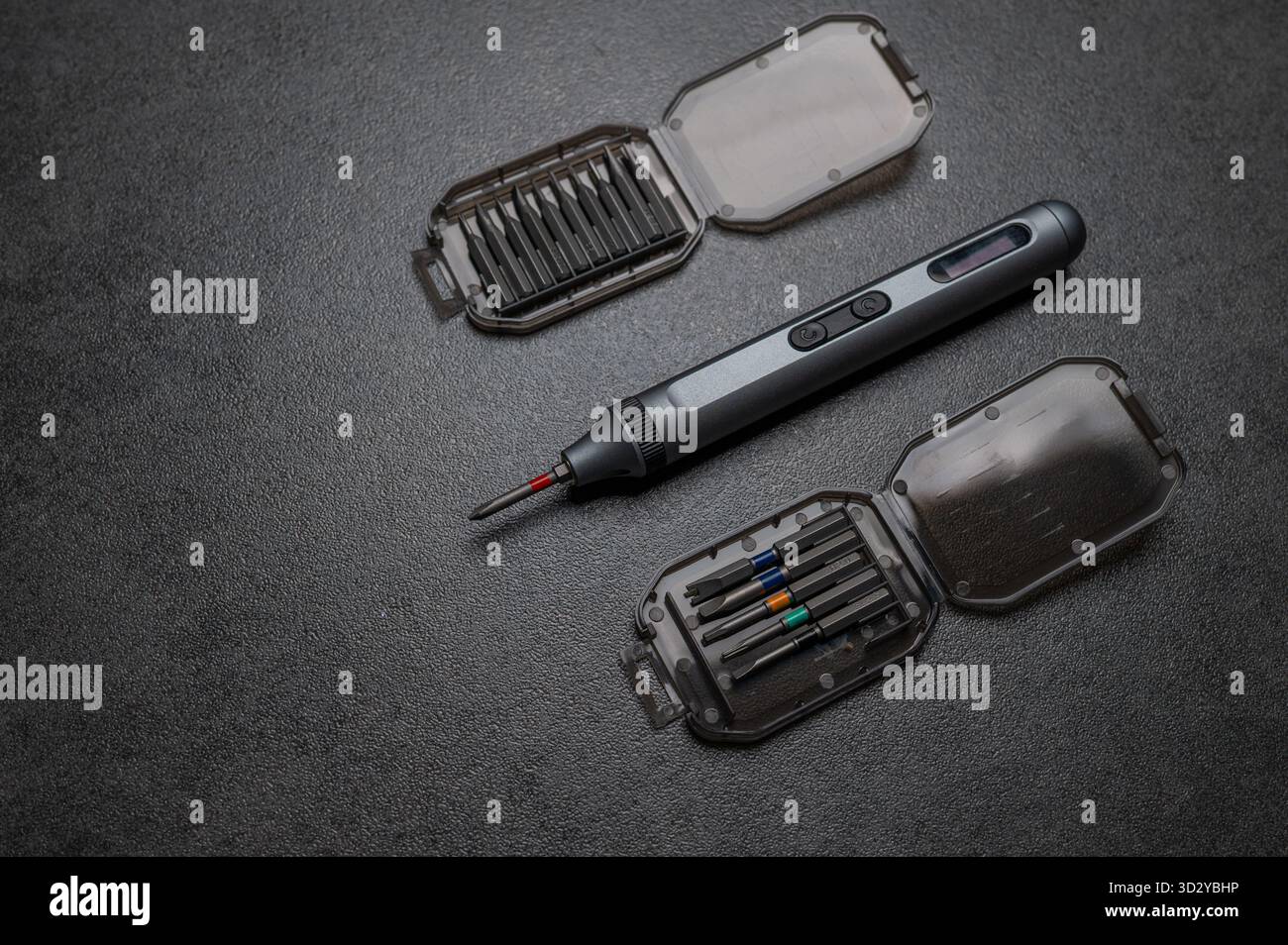 Electric mini screwdriver and several different interchangeable bits Stock Photo