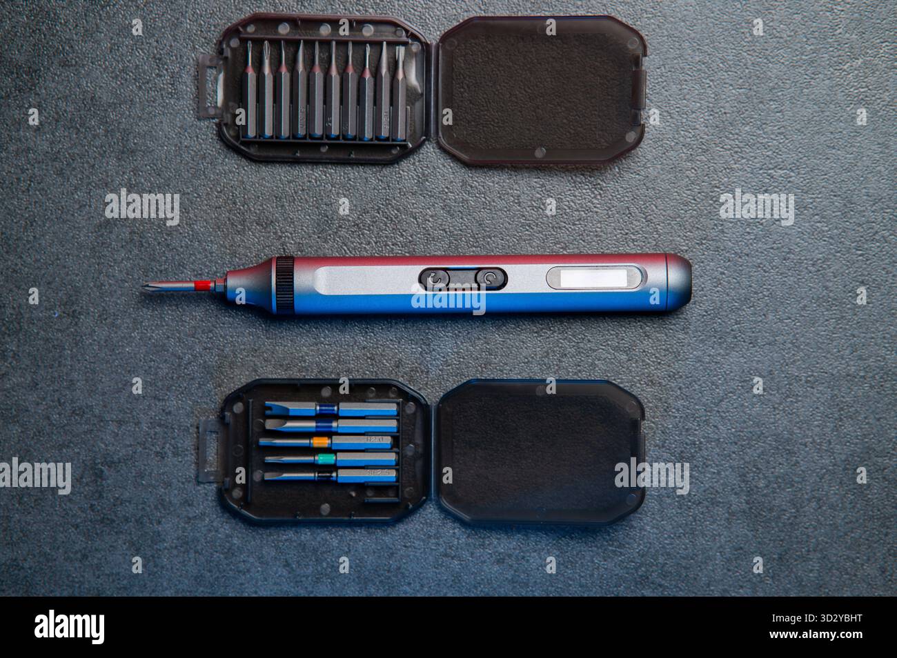 Electric mini screwdriver and several different interchangeable bits Stock Photo