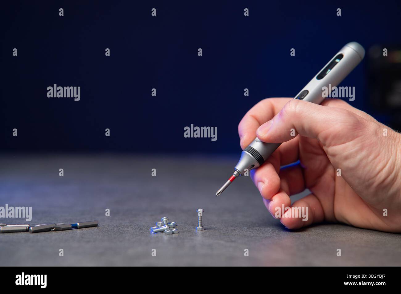 Electric mini screwdriver and several different interchangeable bits Stock Photo