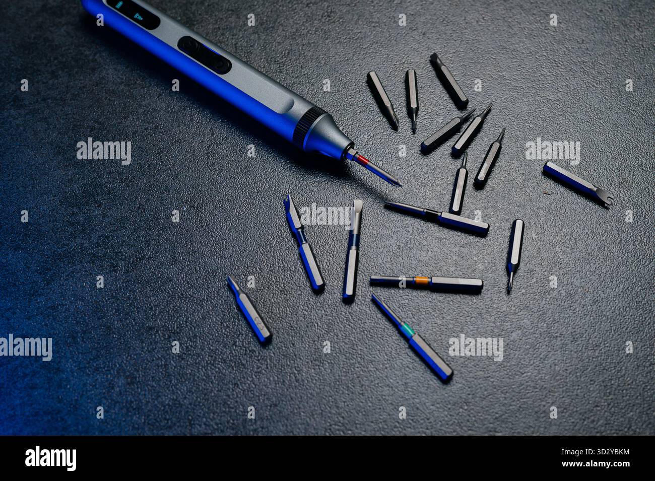 Electric mini screwdriver and several different interchangeable bits Stock Photo