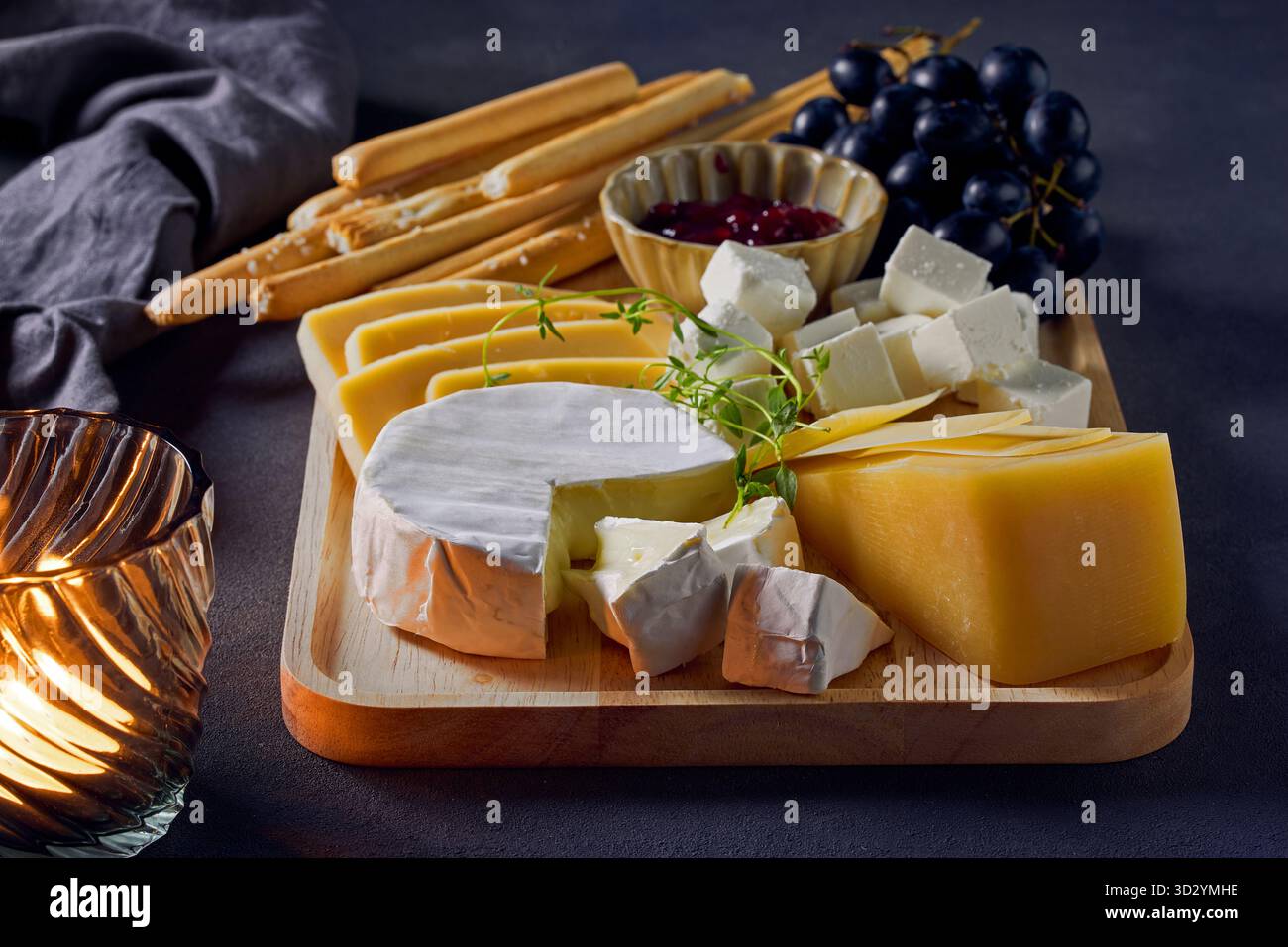 cheese plate and bread sticks on dark grey table background Stock Photo