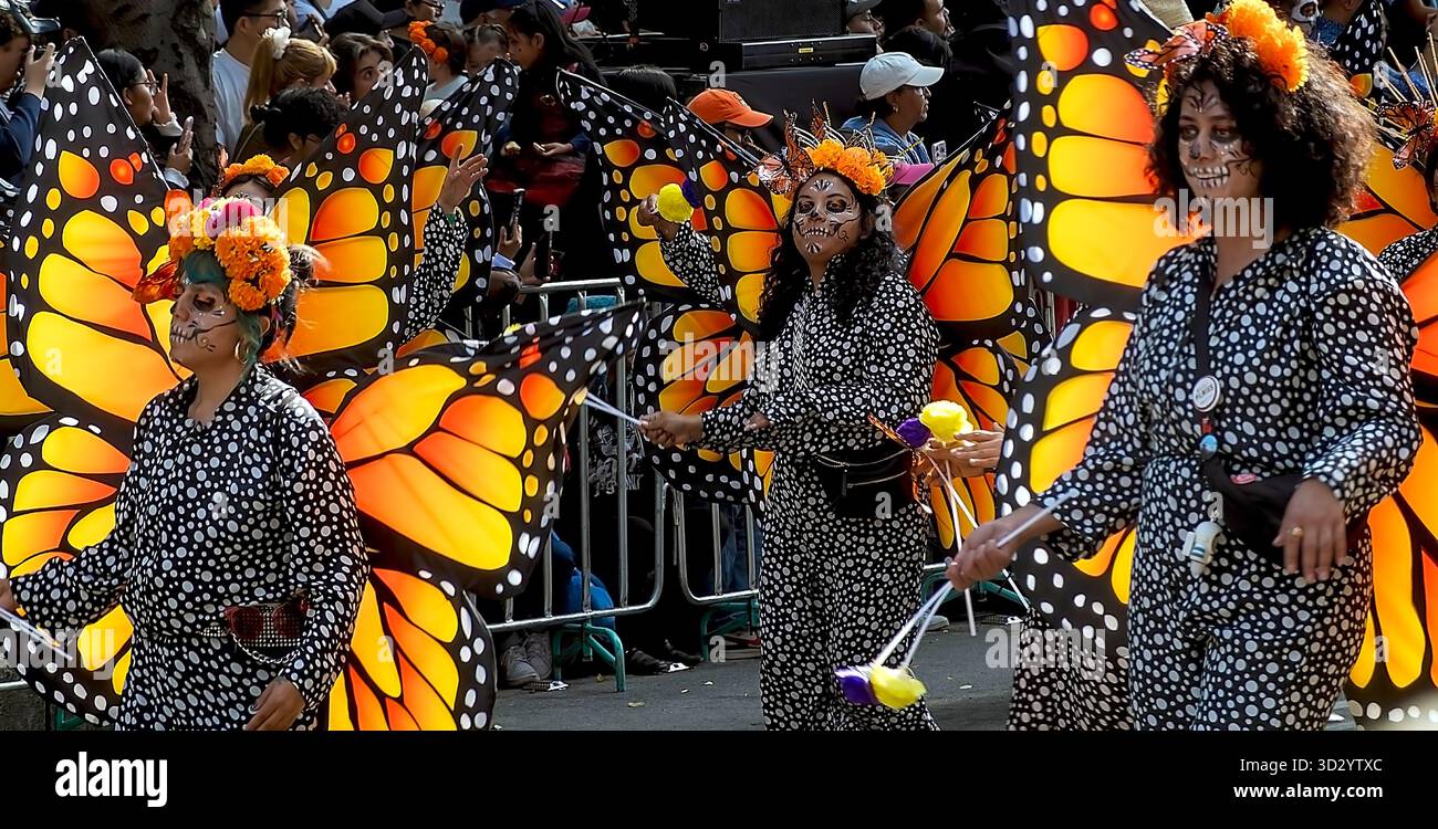 Women in Monarch Butterfly costumes take part in a Day of  the Dead parade in Mexico City, Mexico Stock Photo
