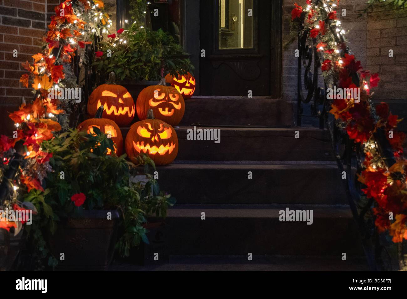 Halloween pumpkins on Queens NY stoop at night Stock Photo