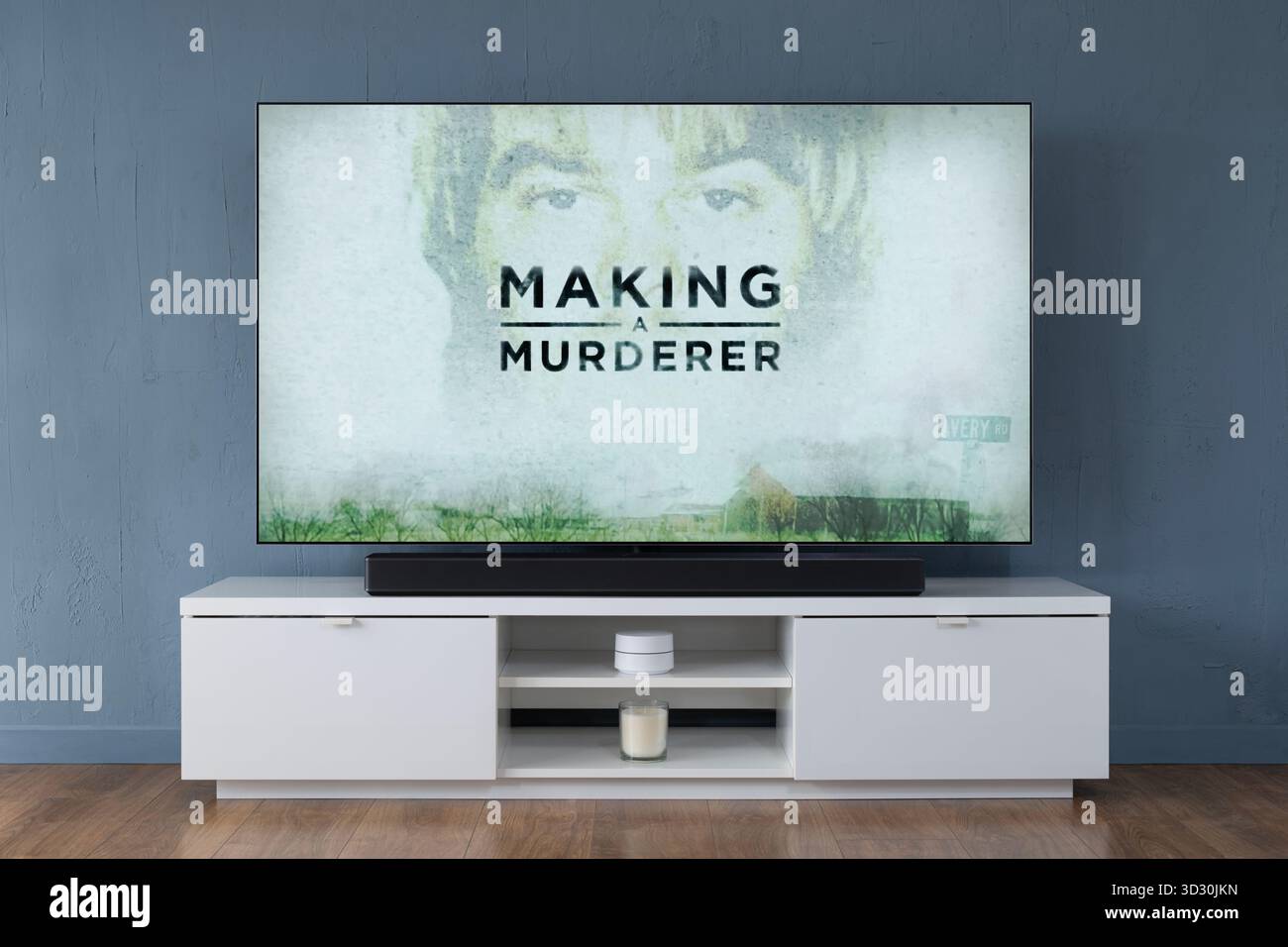 A widescreen OLED television showing the intro scene to the TV series Making A Murderer, seen in a contemporary living room. Stock Photo