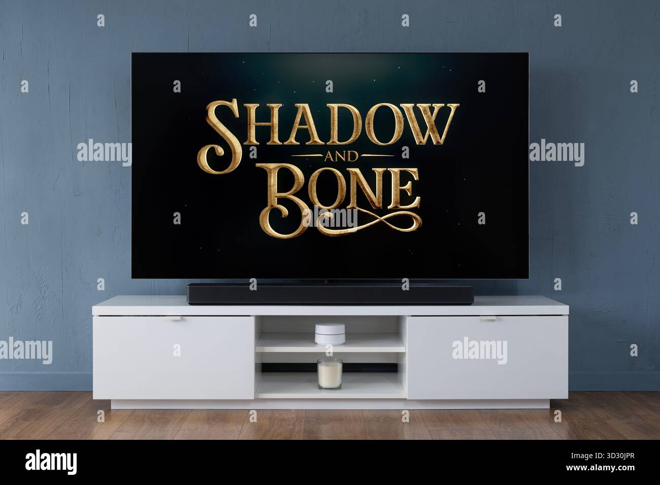 A widescreen OLED television showing the intro scene to the TV series Shadow and Bone, seen in a contemporary living room. Stock Photo