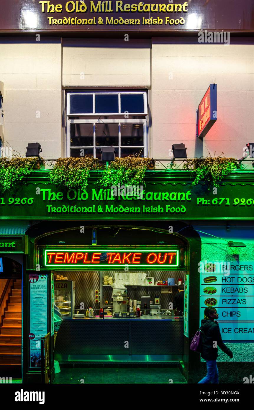 The Old Mill Restaurant Exterior With Neon Green Sign And Traditional Irish Takeout Counter Stock Photo