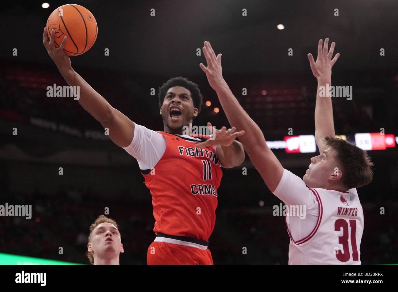 Austin Rapp Oregon Campbell's Muneer Newton shoots between Wisconsin's Nolan Winter and ...