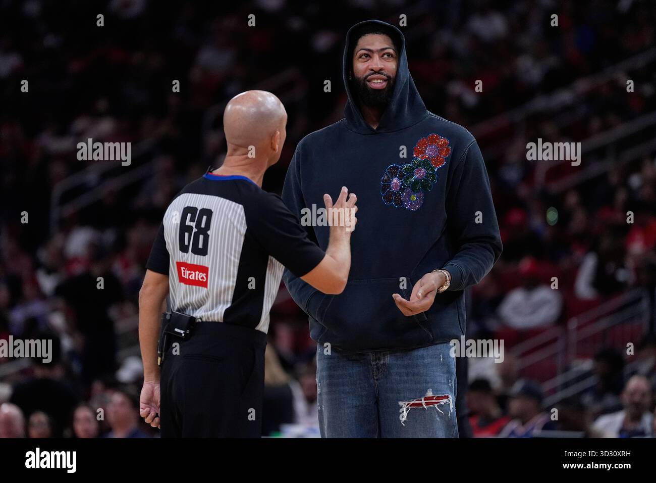 Dallas Mavericks forward Anthony Davis, right, talks with referee Jacyn ...