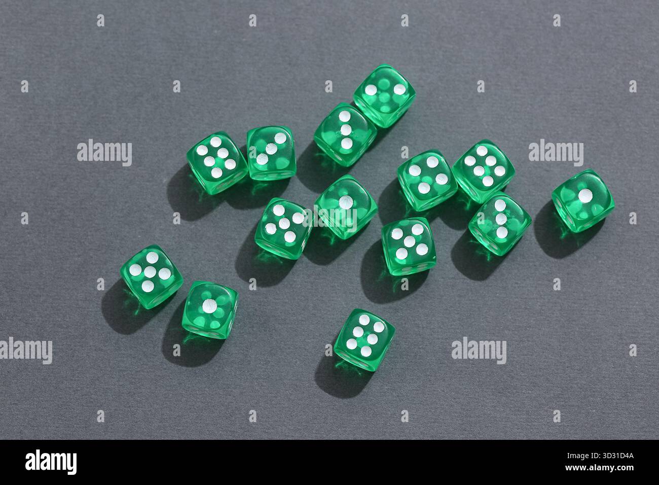 Green game dices on grey background Stock Photo