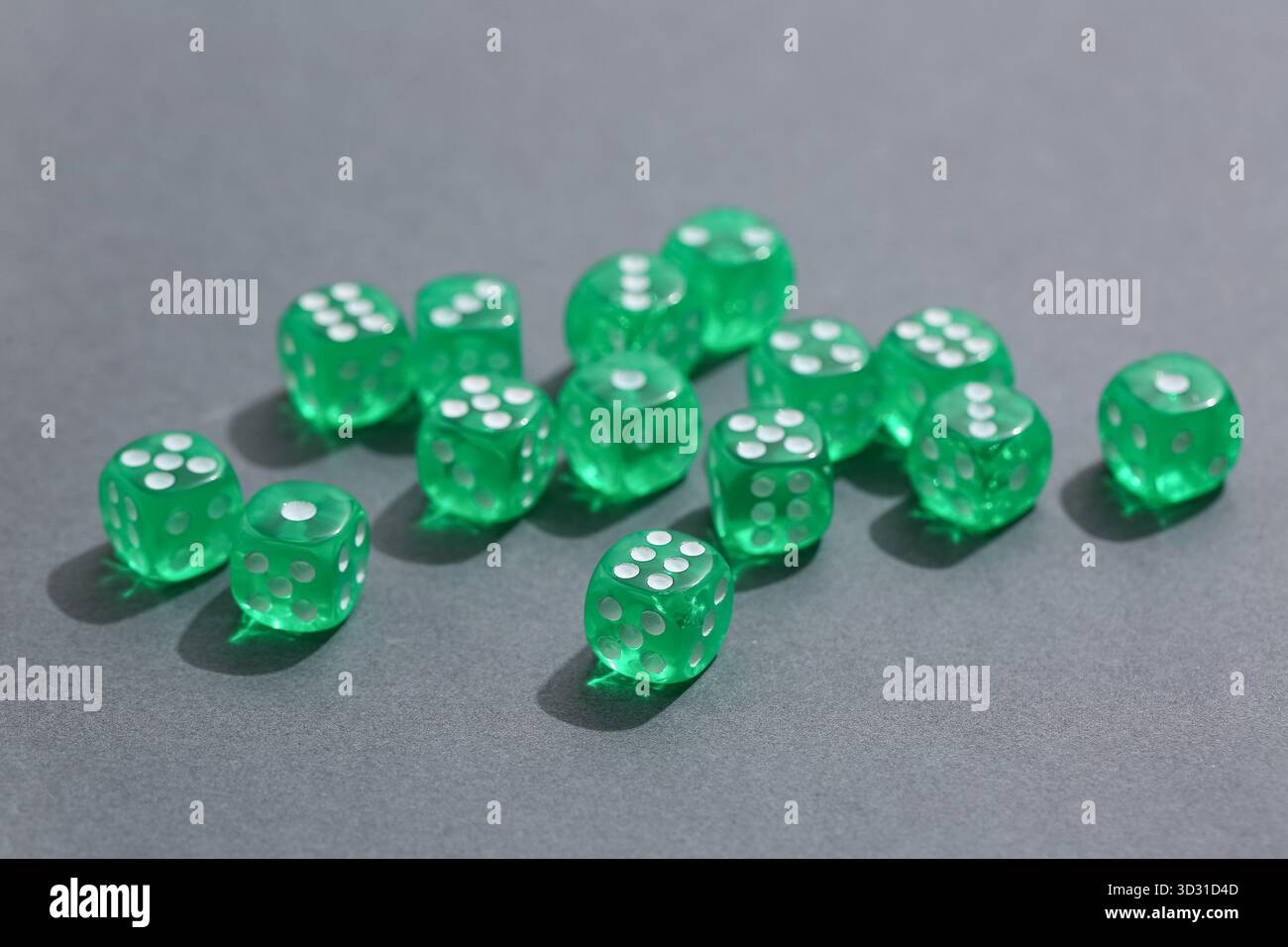 Green game dices on grey background Stock Photo