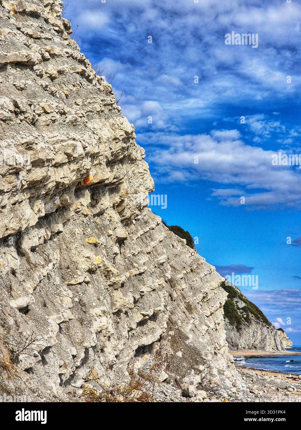Dramatic coastal cliff and blue sky.Rough rock texture against  sea. View seascape with White Cliff - Smartphone Captured Stock Image