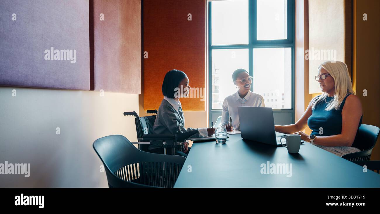 Professional women holding a business meeting in a modern corporate office, discussing ideas and collaborating for a project. Stock Photo
