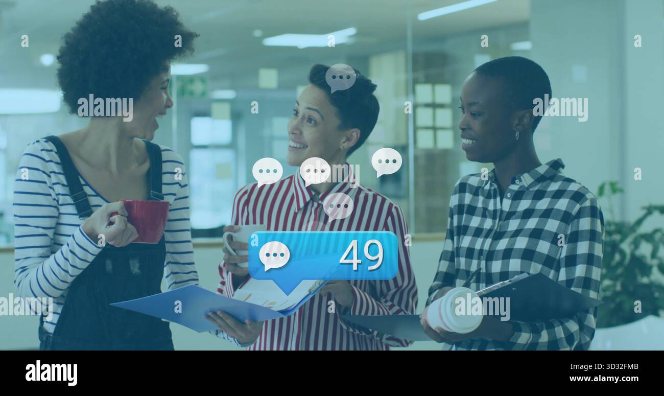 Chatting three colleagues holding coffee cups smartphone in office, chat bubbles notification icon Stock Photo