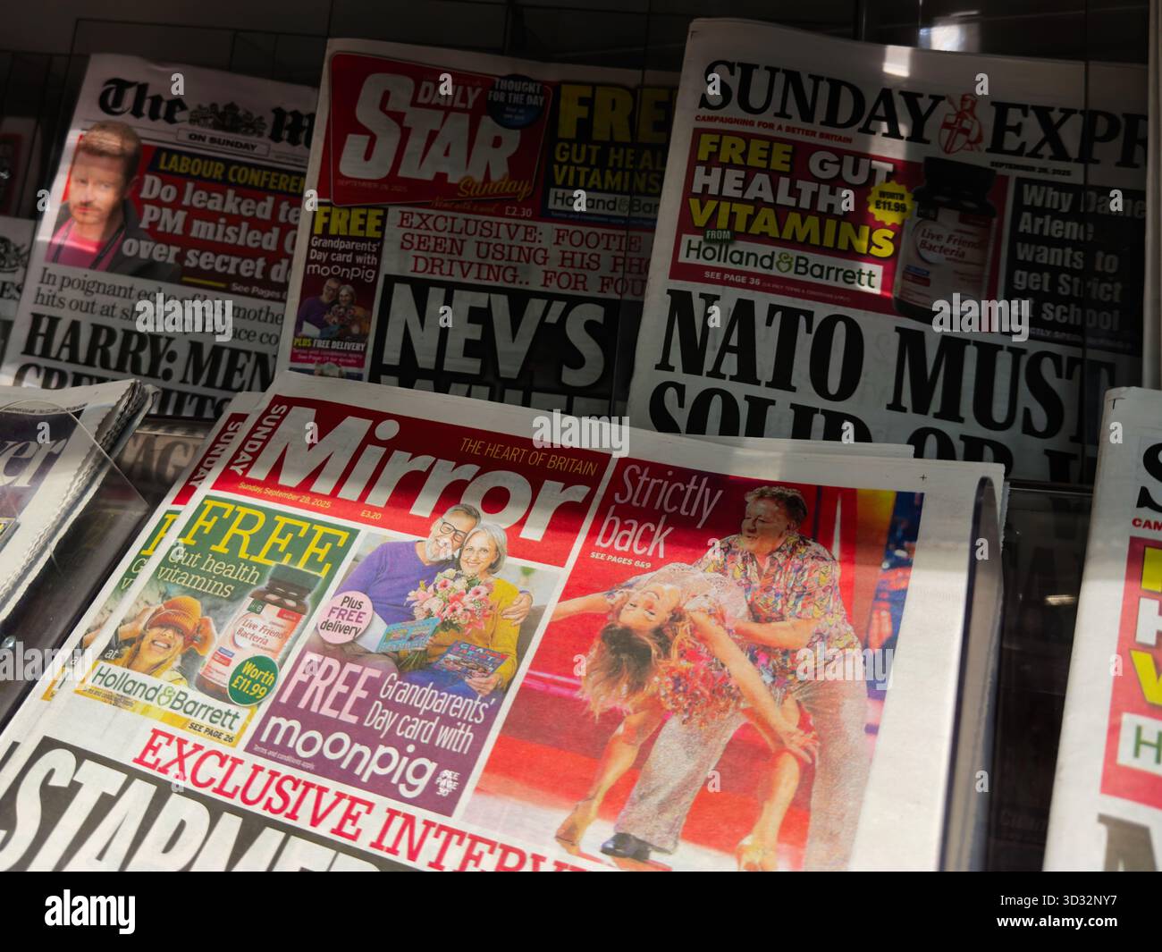 Manchester, UK - September 29, 2025: UK tabloid display with bright headlines and celebrity imagery in Manchester. Stock Photo