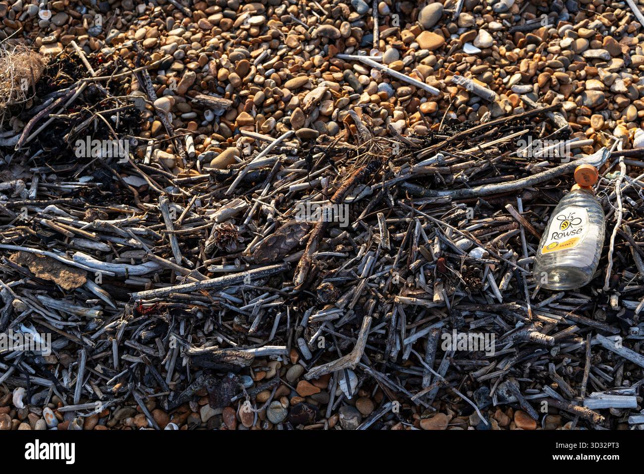 Plastic bottle washed up on the shoreline Stock Photo
