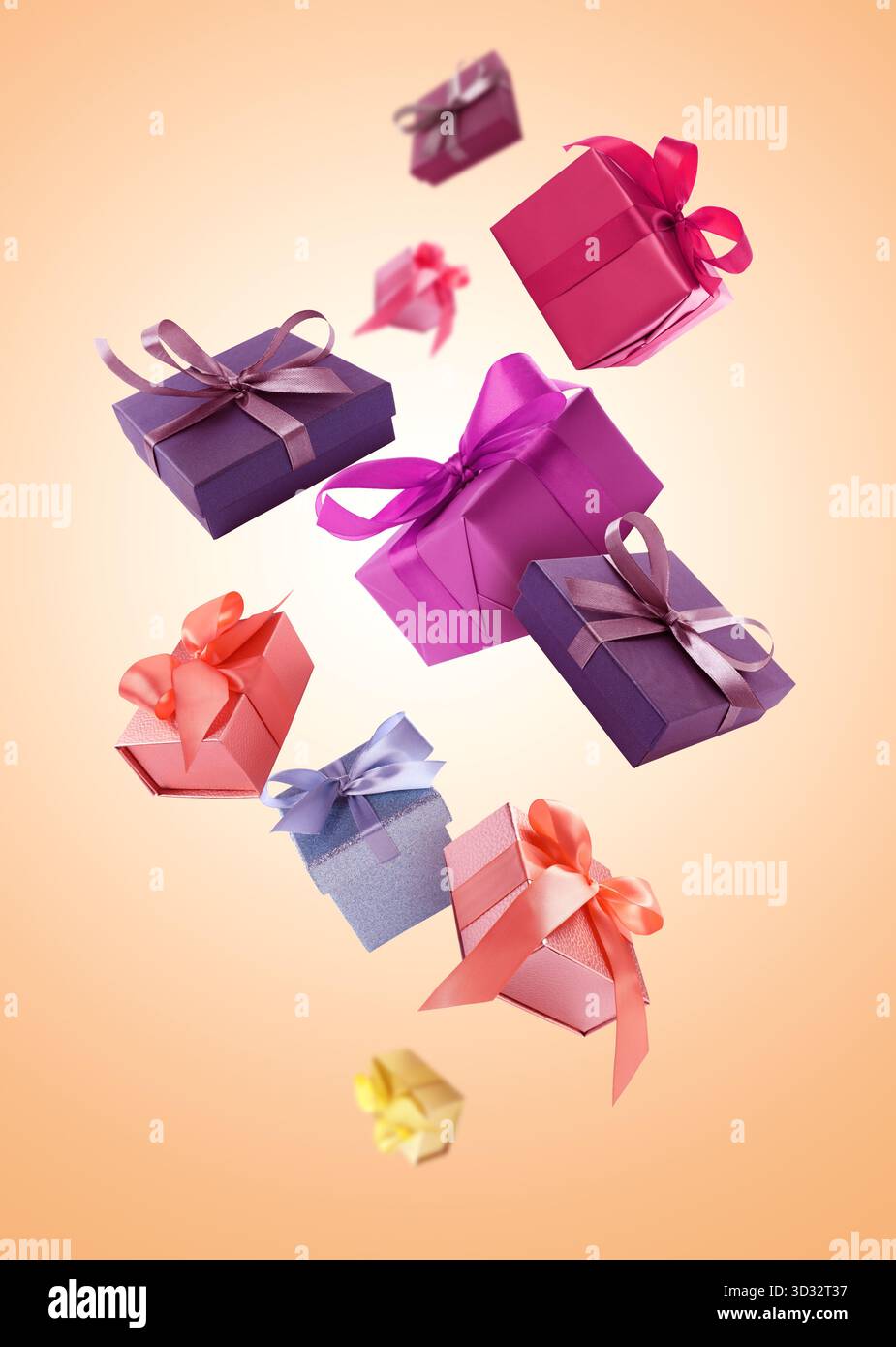 Gift boxes flying in air on coral gradient background Stock Photo