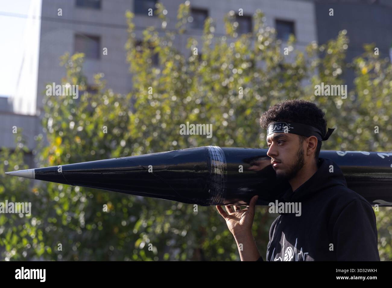 Tehran, Iran. 04th Nov, 2025. A protester carries a model of an Iranian-made missile during a rally marking the 46th anniversary of the U.S. Embassy takeover. Credit: SOPA Images Limited/Alamy Live News Stock Photo