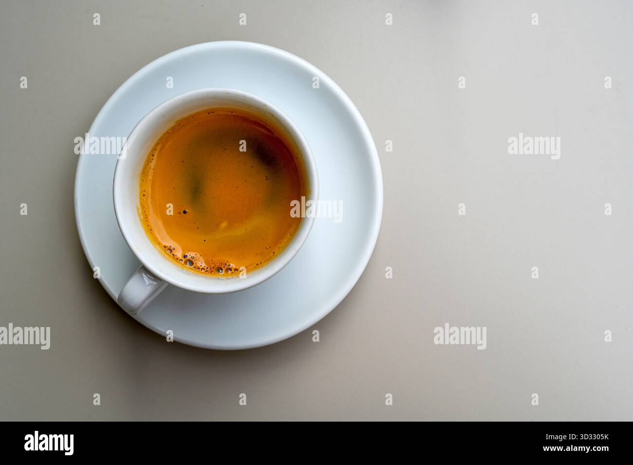 Ceramic white cup with black espresso coffee on a table, space for text Stock Photo