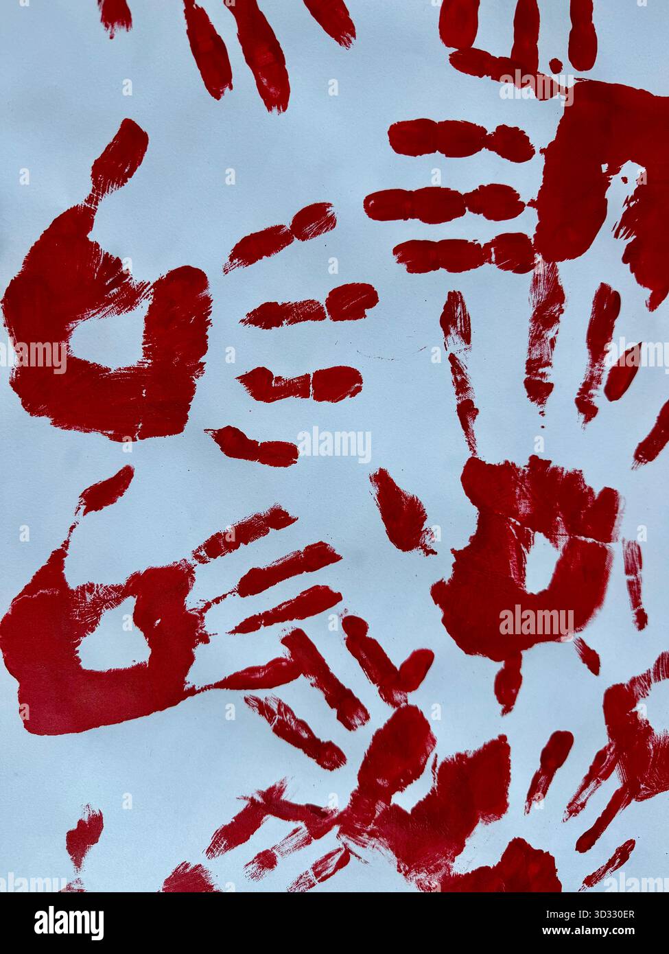 Red handprints on a light background creating an abstract artistic pattern. - Smartphone Captured Stock Image