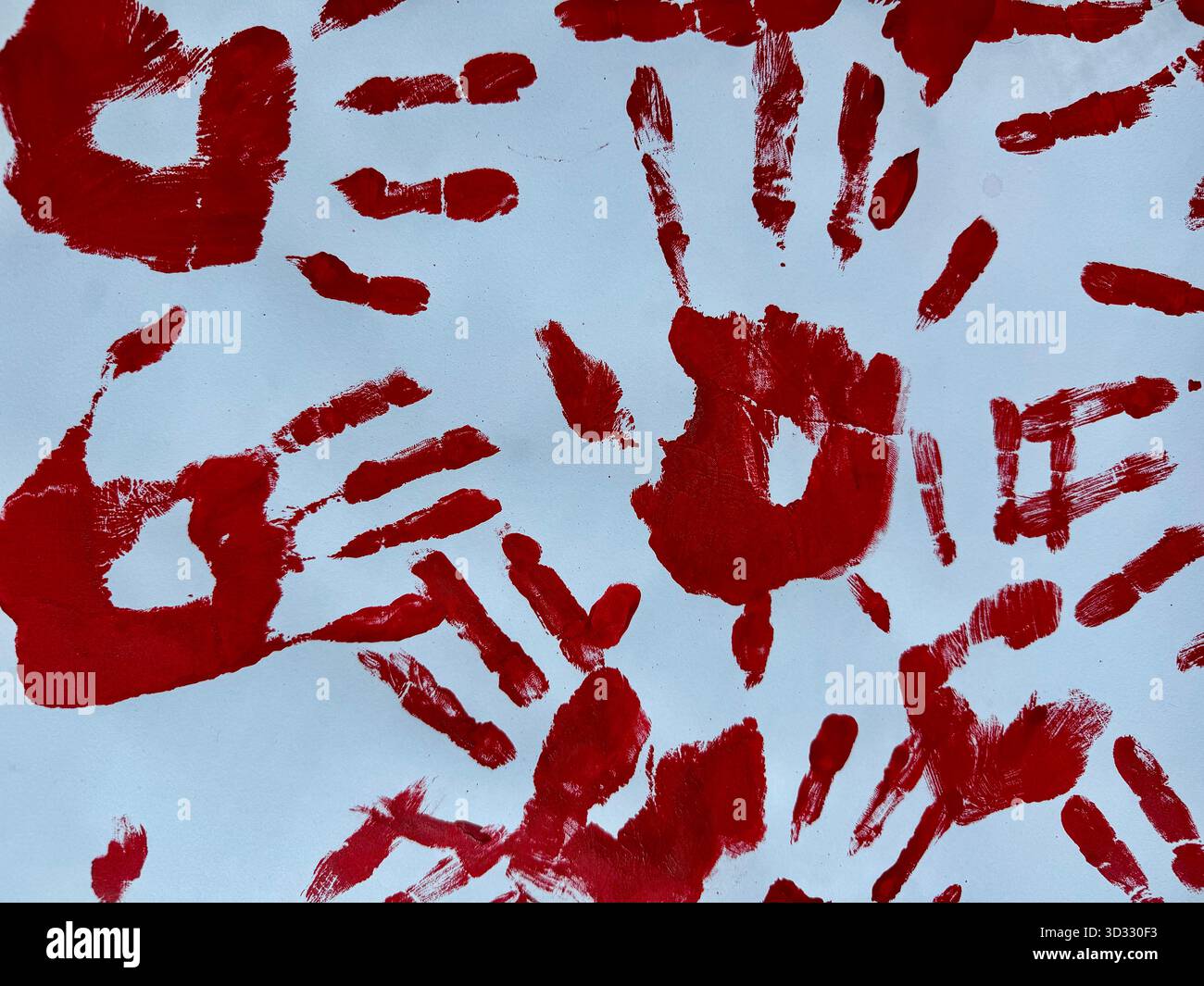 Red handprints on a light background creating an abstract artistic pattern. - Smartphone Captured Stock Image