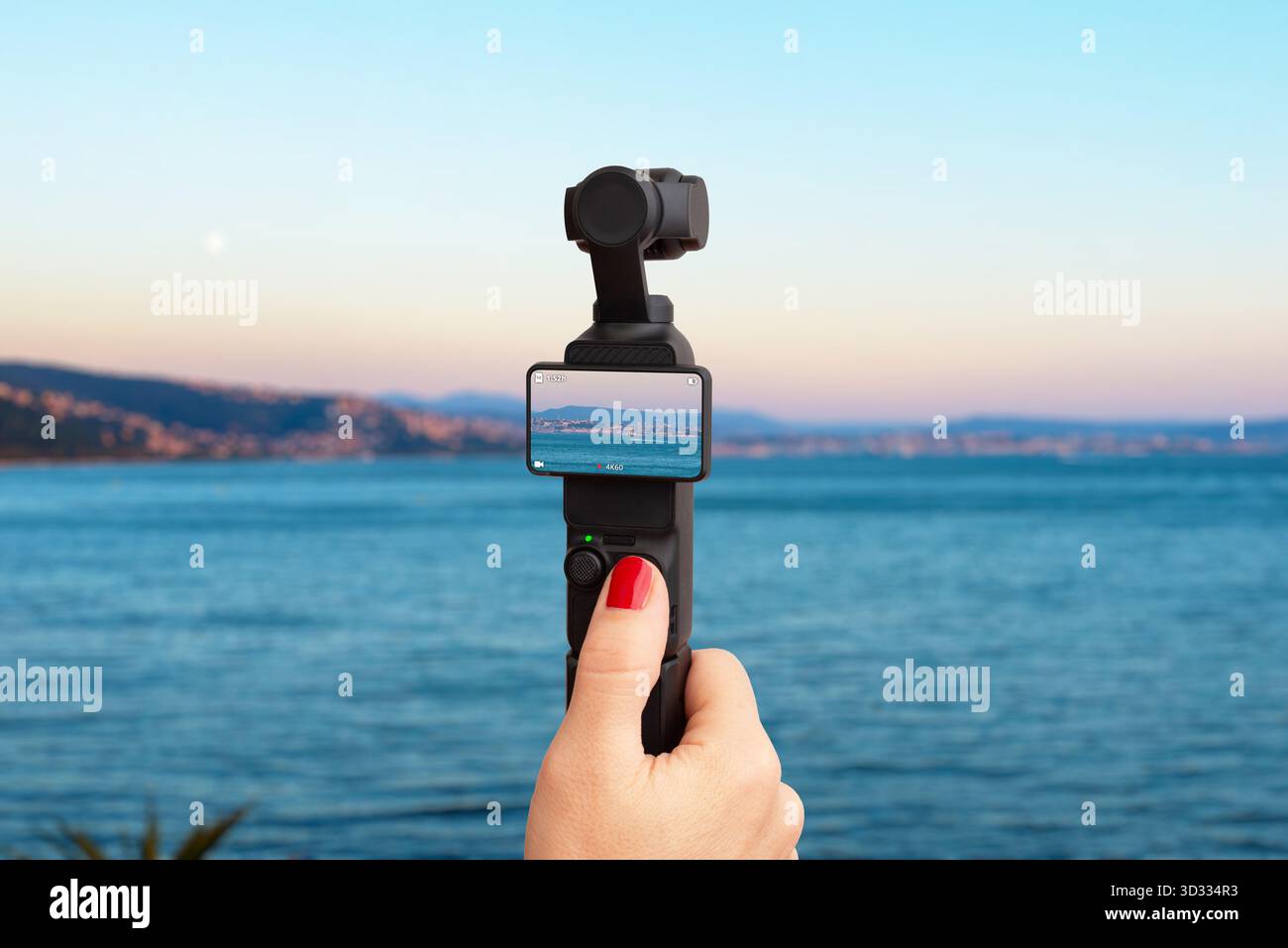 Handheld camera capturing beautiful seaside landscape at sunset, perfect for concepts of travel, creativity, vlogging, freedom and adventure lifestyle Stock Photo