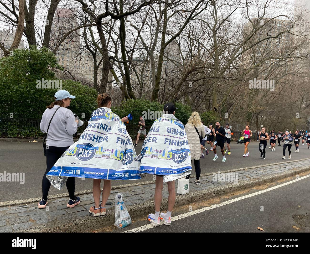 Energy and determination fill the paths of Central Park during a running race. - Smartphone Captured Stock Image