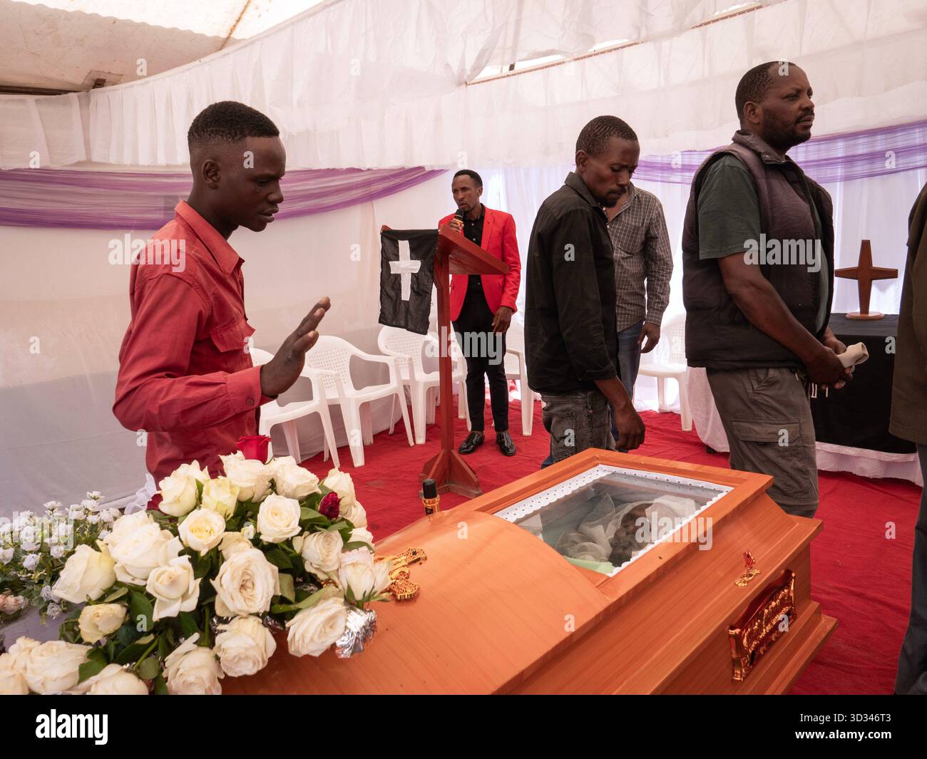 Mourners gather for the funeral of someone who died during post