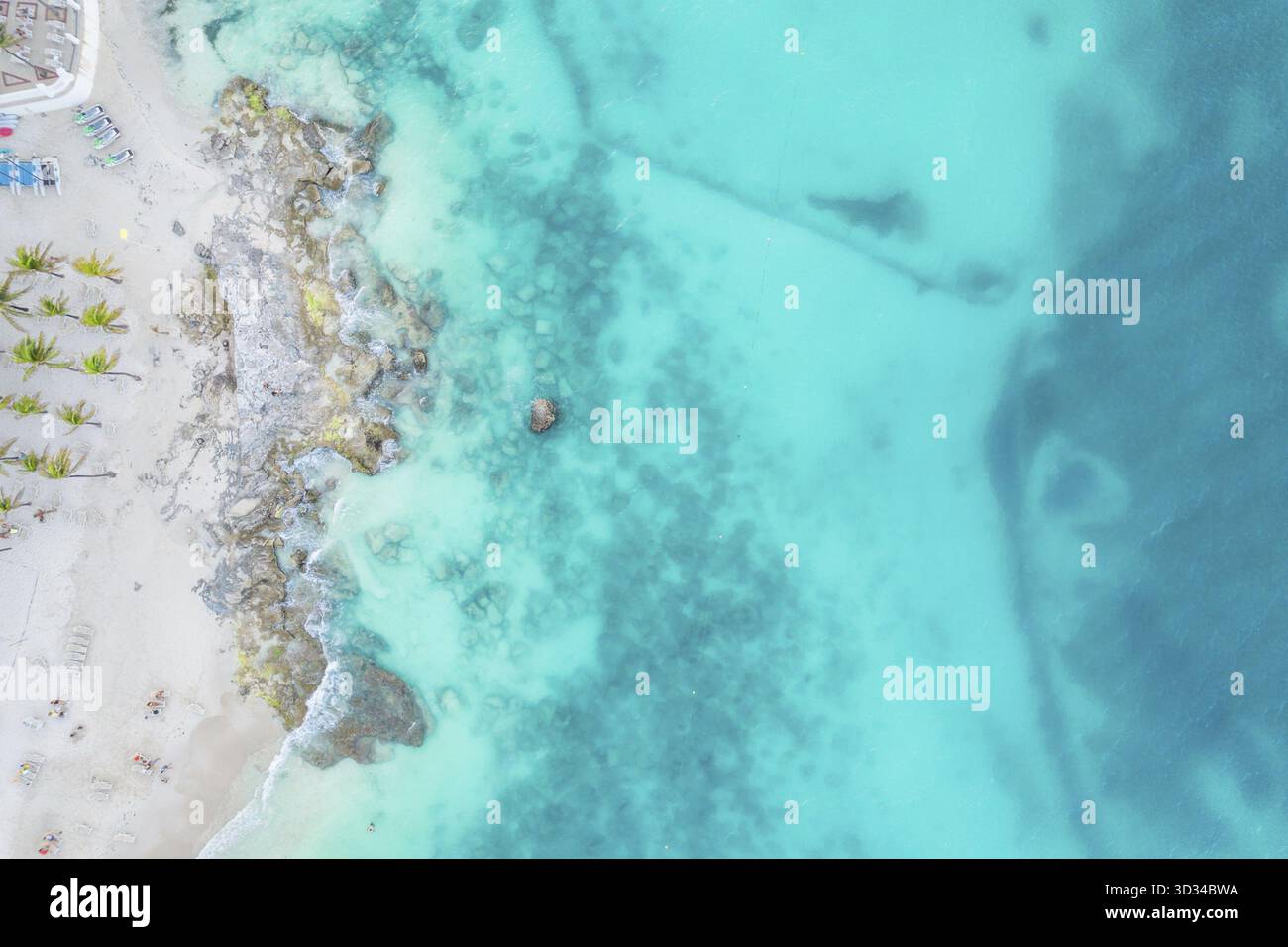 Aerial view of sandy caribbean beach and ocean with rocks and small ...