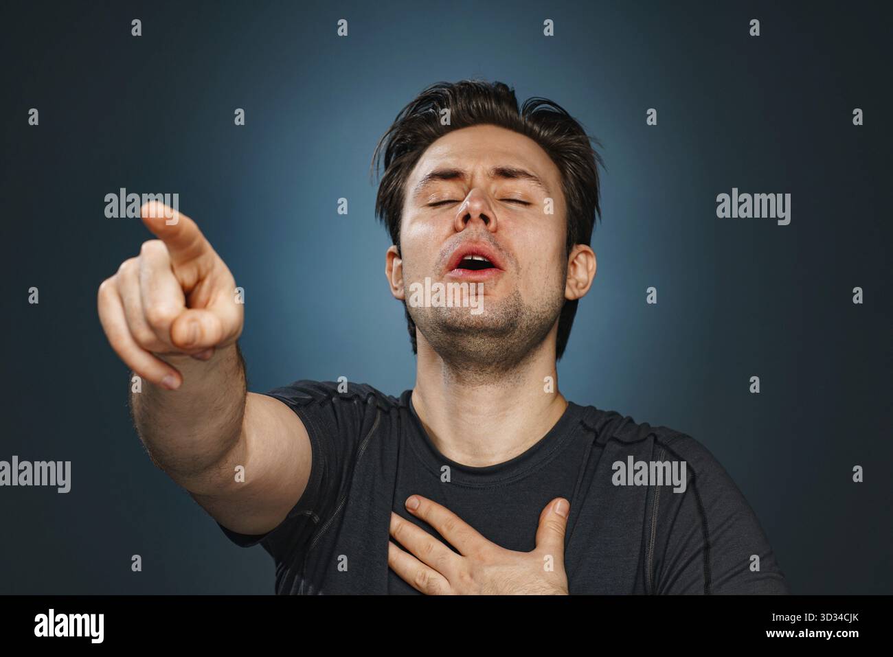 Young man pointing with finger and laughing Stock Photo
