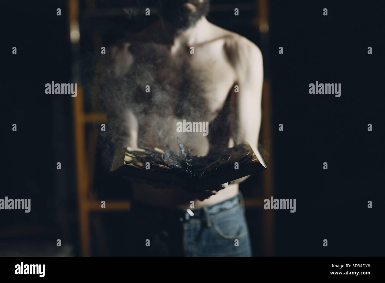 Man hold burning book in his hands Stock Photo