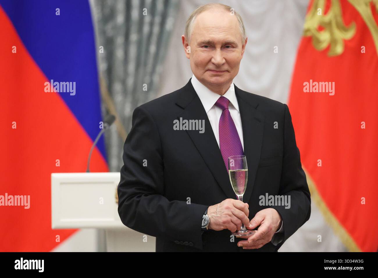 Russian President Vladimir Putin toasts after a ceremony for presenting ...