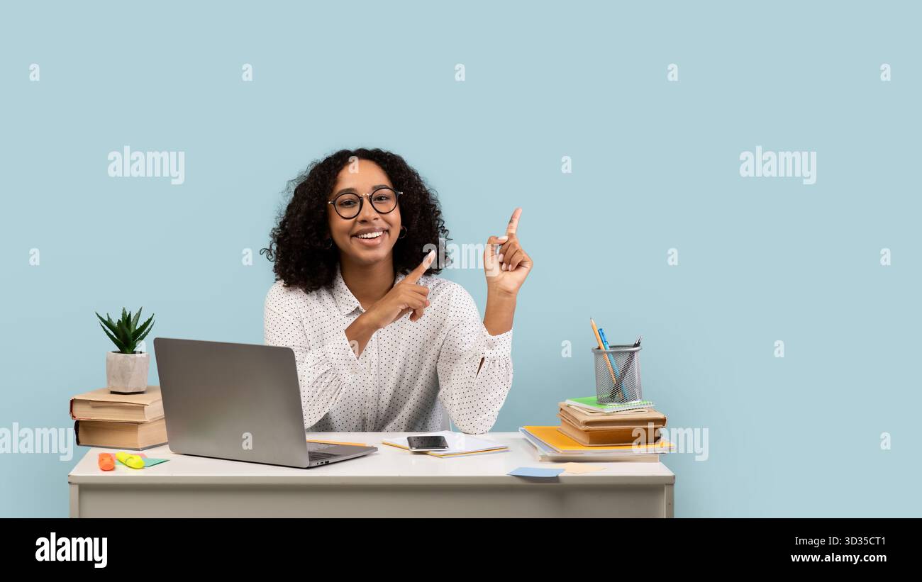 Happy Young Black Female Student Engaged in Online Learning at a Desk ...