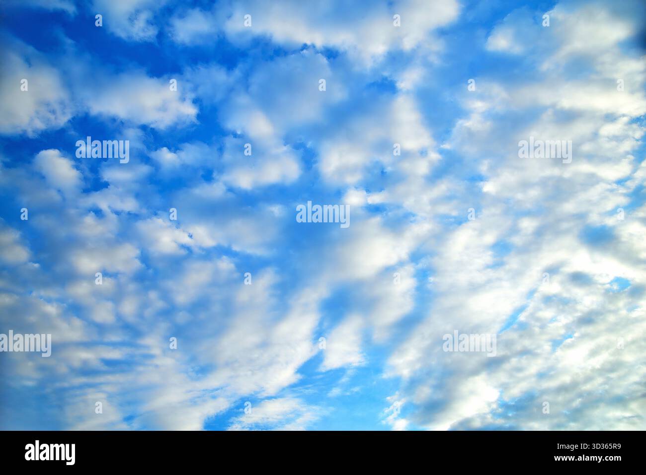 clouds of different shapes in the blue sky illuminated by the sun's rays close-up selective focus Stock Photo