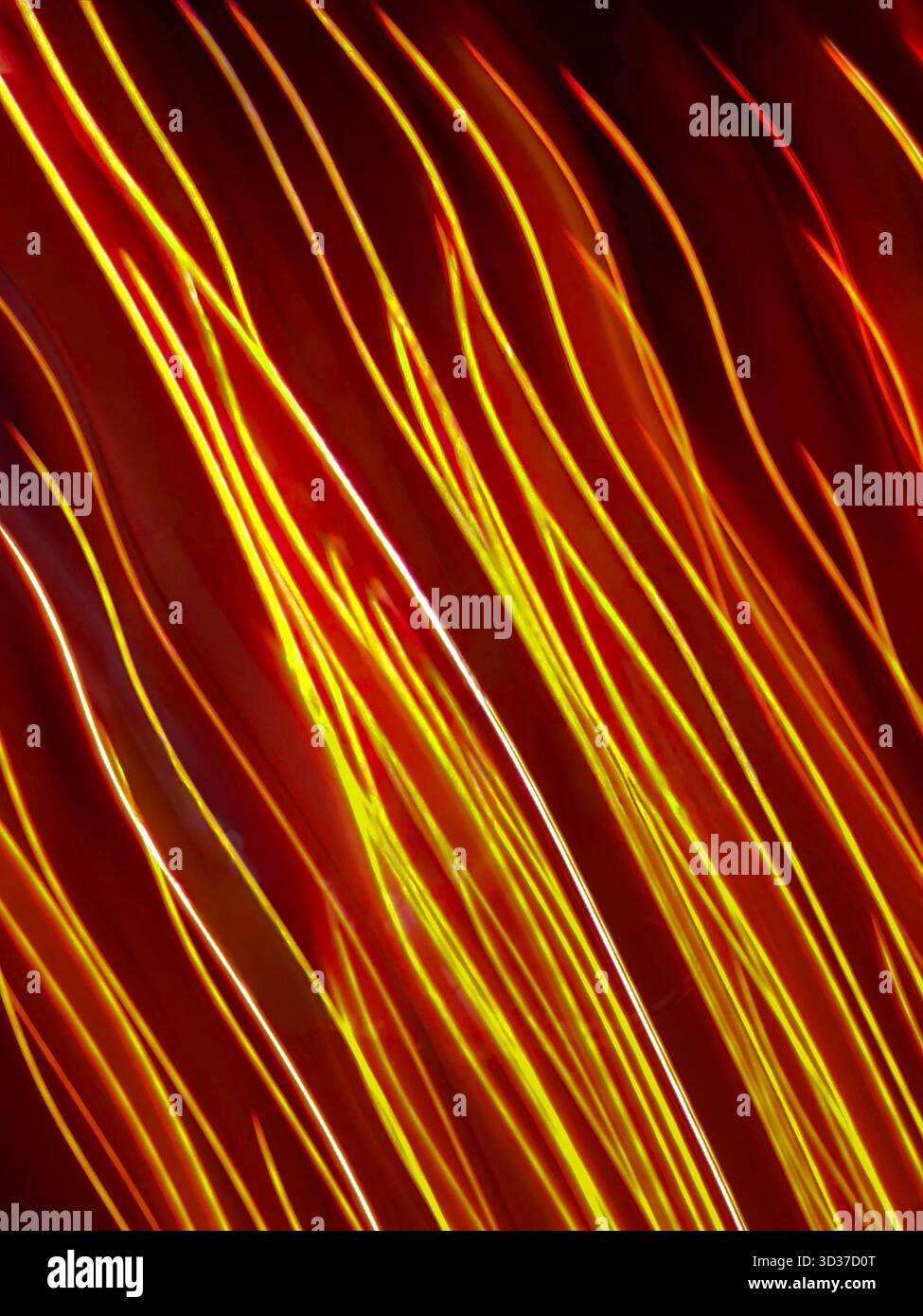 Colorful glow sparks streams of light texture. Orange red rays on dark background .Flare abstract effect. Stock Photo