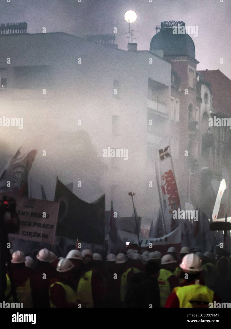 Katowice, Poland. 04th Nov, 2025. Coal miners and steelworks workers hold banners and burn flares as the Beaver Moon shines during a protest in front of Silesia voivodeship government office. Labour unions, primarily Solidarity movement, of mining and steel industries called for protest as negotiations with the Polish government on the issue of energy transformation did not bring satisfactory results. This week, the Polish government adopted a draft law which will protect miners leaving the industry, but the union say the law is not enough. Credit: SOPA Images Limited/Alamy Live News Stock Photo