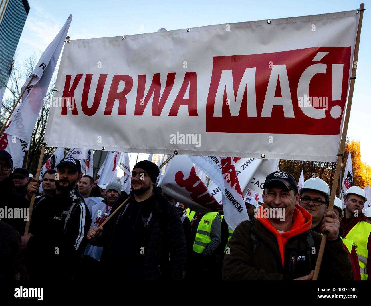 Katowice, Poland. 04th Nov, 2025. Coal miners and steelworks workers hold banners with names of their labour unions and with a swearword during a protest. Labour unions, primarily Solidarity movement, of mining and steel industries called for protest as negotiations with the Polish government on the issue of energy transformation did not bring satisfactory results. This week, the Polish government adopted a draft law which will protect miners leaving the industry, but the union say the law is not enough. Credit: SOPA Images Limited/Alamy Live News Stock Photo