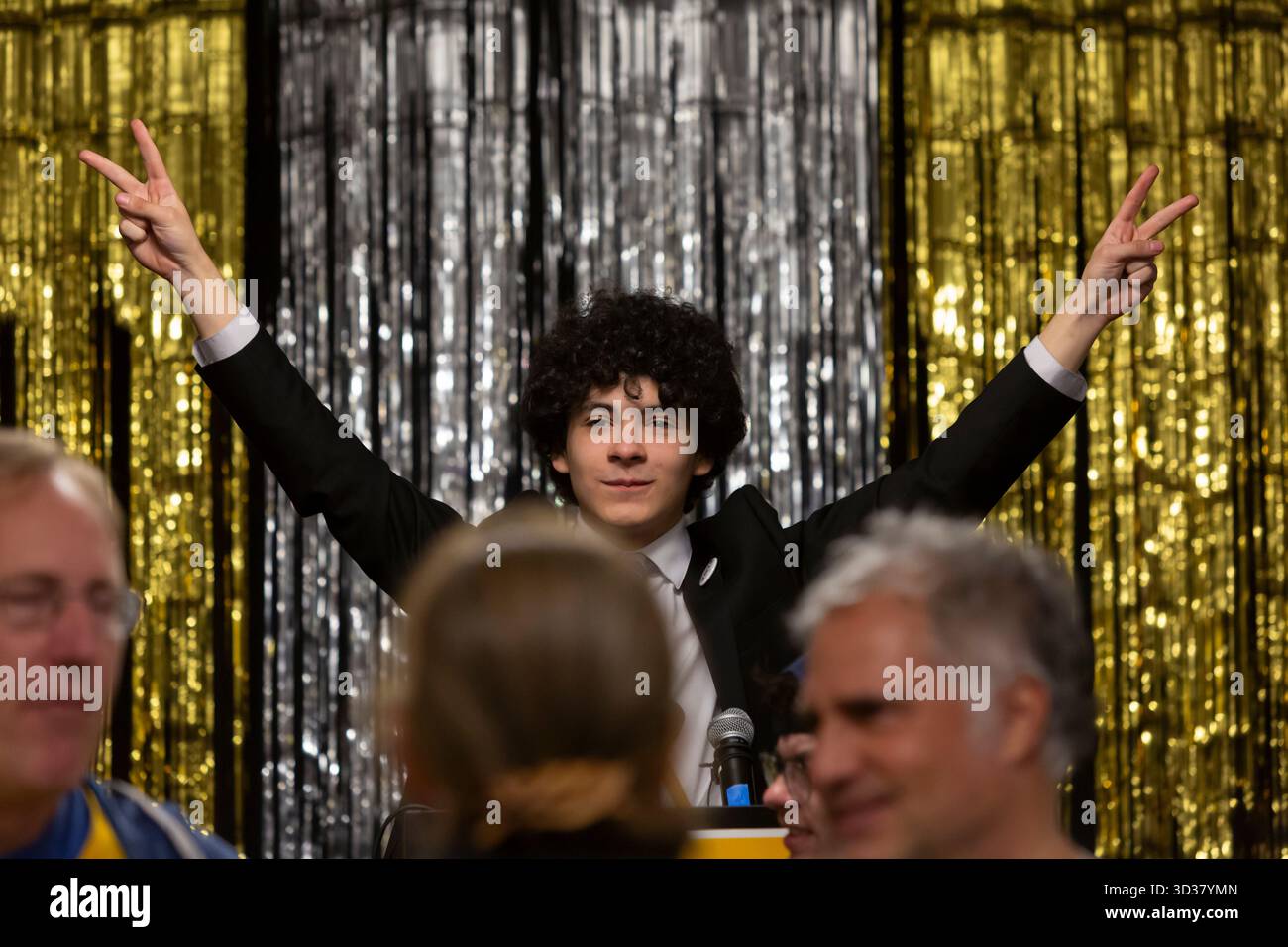 Seattle, Washington, USA. 4th November 2025. Campaign volunteer Sadie Stuart holds the podium at the Wilson for Mayor election night party at El Centro de la Raza. Progressive candidate Katie Wilson led the incumbent Seattle mayor Bruce Harrell by a healthy margin winning an outright majority in the top-two primary. Credit: Paul Christian Gordon/Alamy Live News Stock Photo