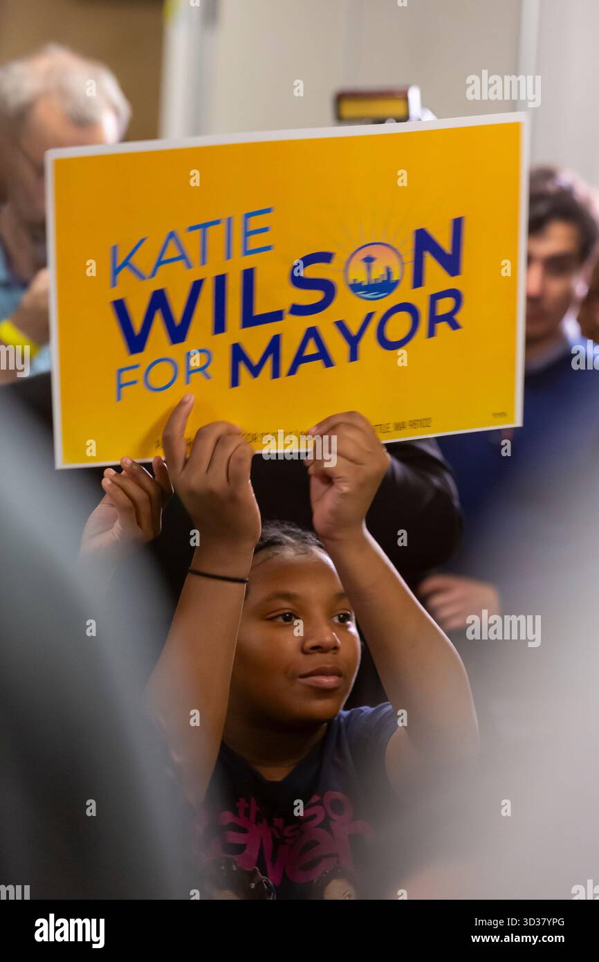 Seattle, Washington, USA. 4th November 2025. A young supporter holds a campaign poster of Katie Wilson during an election night party at El Centro de la Raza. Progressive candidate Katie Wilson led the incumbent Seattle mayor Bruce Harrell by a healthy margin winning an outright majority in the top-two primary. Credit: Paul Christian Gordon/Alamy Live News Stock Photo
