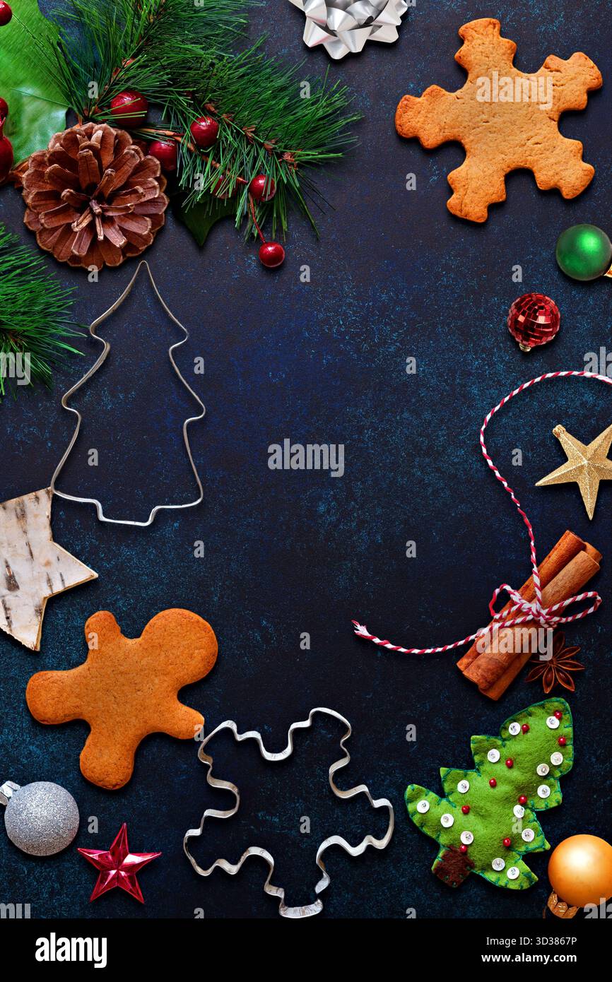 Christmas Cookie Cutters and Decorations on Dark Surface Stock Photo