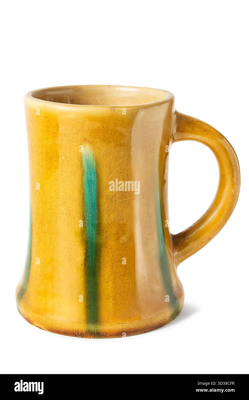 Yellow ceramic craft mug isolated on white bakground Stock Photo